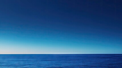 Obraz premium A serene blue horizon merges seamlessly with the ocean, evoking a sense of calm and tranquility in this breathtaking seascape.