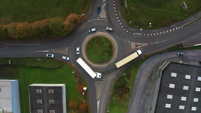 prise de vue a&eacute;rienne d'un petit rond point avec de la circulation dans une zone industrielle dans le nord de la France