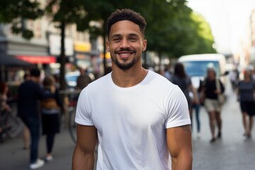 A man in a white shirt is smiling