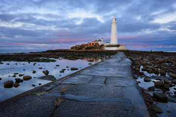 St Mary's Lighthouse at sunset, on the small rocky St Mary's Island, just north of Whitley Bay on the North East coast of England