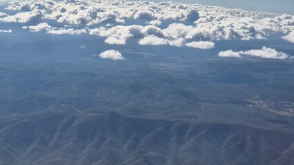 Mountains and rivers of Spain as they are seen from the airplane, cloudy sky over Spanish land