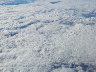 Airplane flying over white clouds background
