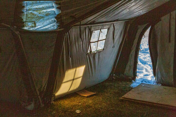 Winter Light Streaming Into An Army Tent In Snowy Conditions
