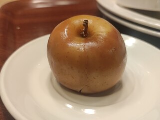 Baked apple on a plate close view background