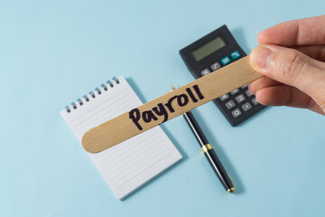 Financial concept with handwriting payroll on ice cream stick