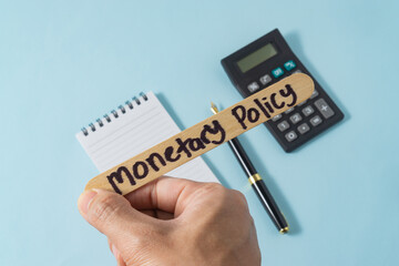 Financial concept with handwriting monetary policy on ice cream stick