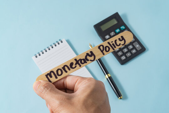 Financial concept with handwriting monetary policy on ice cream stick