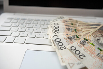 Pln 200 zloty Polish money on laptop keyboard