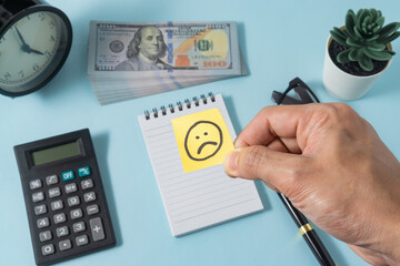 Financial concept with a sad emoji on ice cream stick