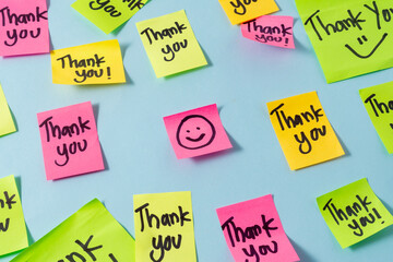 Motivational words for personal development, thank you, inspirational handwriting on sticky notes with a smile emoji