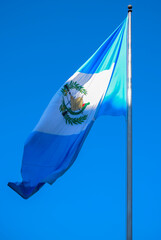 Flag of Guatemala, free in the wind with blue sky, coat of arms, Central America. September 15...