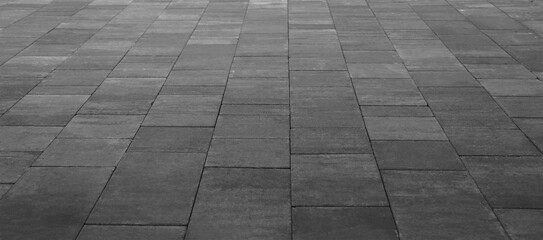Empty grey tiled floor, pavement in perspective on modern architecture background. Abstract concrete glass building, Outdoor observation deck. street urban tile flooring. paving stones. blurred city