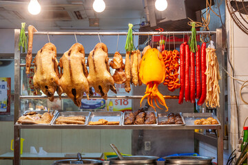 Naklejka premium delicious food like dugs,sausages, vegetables at the night market fresh grilled in Hongkong
