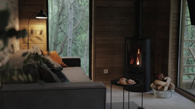 A Cozy Modern Interior Featuring a Fireplace That Invites Natural Light Throughout the Space