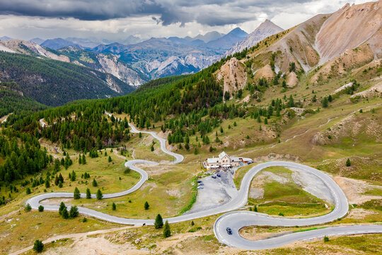 IZOARD PASS, FRANCE: winding road and "Refuge Napoleon" hotel,  road towards Cervieres and the North, top of famous high altitude alpine pass, Mercantour National Park, Alpes de Haute Provence