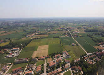 aerial view of the town with houses and cultivated fields of plain