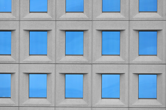 detail of windows with bluish glass on a modern skyscraper used as office space