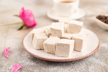 Coffee marshmallow with cup of coffee on brown concrete. side view, selective focus