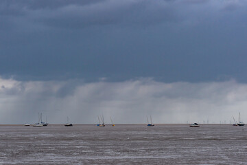 Boats on estuary at low tide