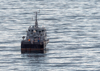 Sea freighter sailing in the middle of the ocean with big waves