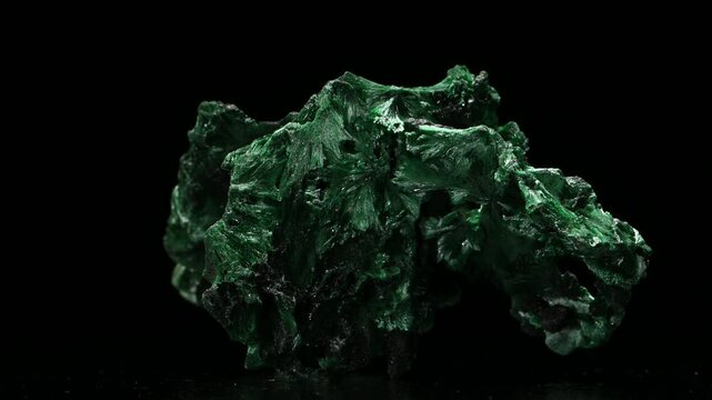 Fibrous Malachite (copper carbonate hydroxide) sample rotating slowly against a black background.