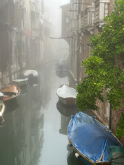 Early foggy morning canal in venice