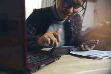 Budget and Tax planning concept. Acountant hand using calculator and review tax form. Represents personal finance, tax preparation, and budgeting, season to pay tax.