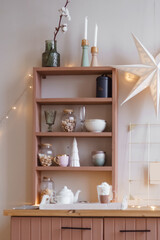 Cozy kitchen with wooden shelves and festive decorations. Demonstrating the colors of 2025 year - Mocha Mousse