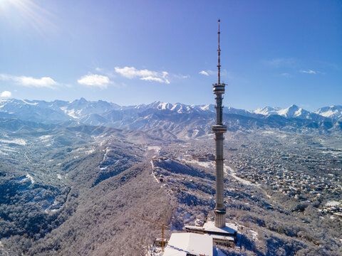 TV tower on Kok Tobe mountain, the symbol of Almaty city in winter after the first snowfall.