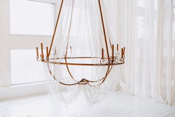 Elegantly draped chandelier adds charm to festive winter decor