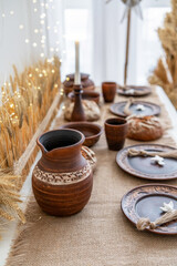 Rustic winter tabletop with handmade pottery for Christmas