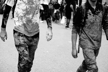 two young volunteers dirty with mud after helping in the clean-up after the floods in valencia