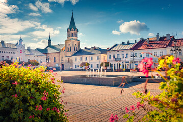 Marvelous autumn view of market square with spire of Klasztor Franciszkanow Monastery. Impressive morning cityscape of Sanok town,  Subcarpathian Voivodeship of southeastern Poland, Europe.