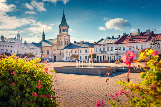 Marvelous autumn view of market square with spire of Klasztor Franciszkanow Monastery. Impressive morning cityscape of Sanok town,  Subcarpathian Voivodeship of southeastern Poland, Europe.