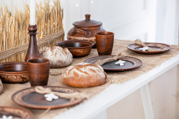 Festive winter table setting with rustic bread and wooden bowls for Christmas