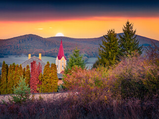 Colorful autumn dawn in Krasnohorska Podhradie village and municipality in the Roznava District in...