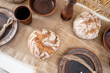 Festive winter table setting with homemade bread and rustic decor for Christmas