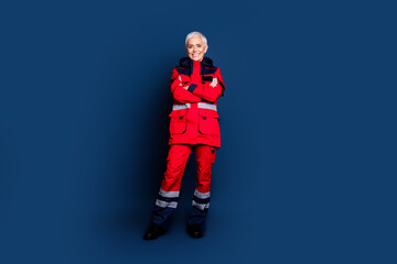 Full length photo of lovely retired lady crossed hands wear uniform paramedic experienced doctor medicare isolated on dark blue background