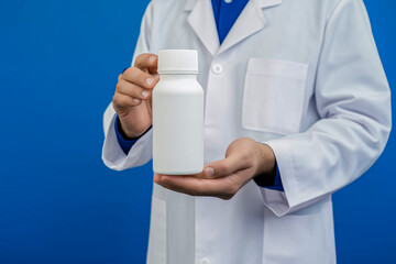 a man in a doctor's coat holds a white pill jar in his hands. for advertising. for business. for banners.