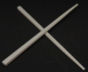 small eating chopsticks, children's eating chopsticks in white on a black background