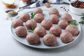 Many fresh raw meatballs on light table
