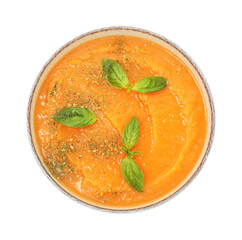 Delicious sweet potato soup with basil in bowl isolated on white, top view