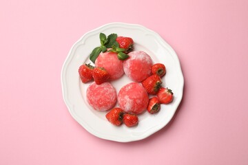 Delicious mochi, strawberries and mint on pink background, top view
