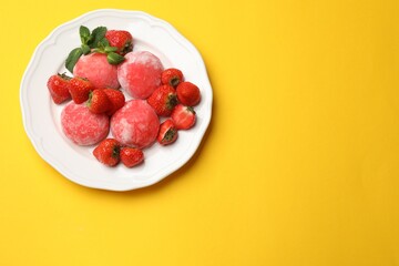 Delicious mochi, strawberries and mint on yellow background, top view. Space for text