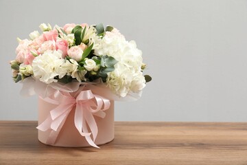 Bouquet of beautiful flowers on wooden table, space for text