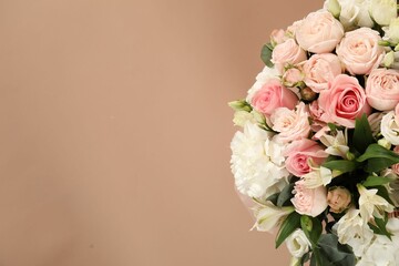 Bouquet of beautiful flowers on beige background, top view. Space for text