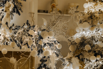 Elegant Christmas decorations with white ornaments and glowing lights