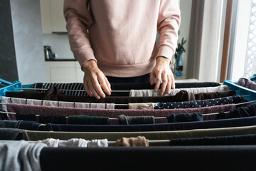 Woman Hanging Laundry Indoors