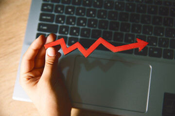 businesswoman using laptop with financial chart