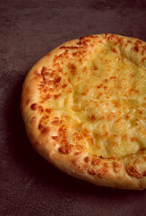khachapuri in Megrelian, a traditional Georgian dish, flatbread with cheese, top view, no people,